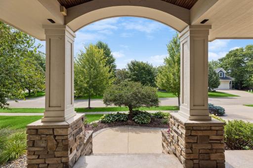 The inviting entry features a wood barrel ceiling and a beautiful decorative wood front door.