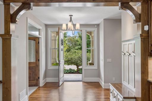 The bright, spacious entryway features gorgeous hickory hardwood floors and a built-in bench with hooks.