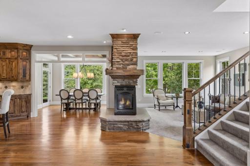 The main level features the desired open layout that centers around a 3-sided gas stone fireplace. The wall of windows overlooking the backyard fills the home with natural light.