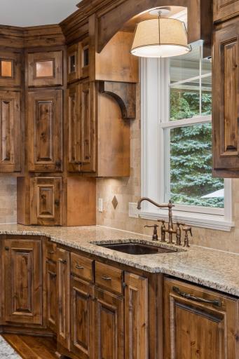 In addition to beautiful light fixtures, the kitchen kitchen window fills the room with natural light.