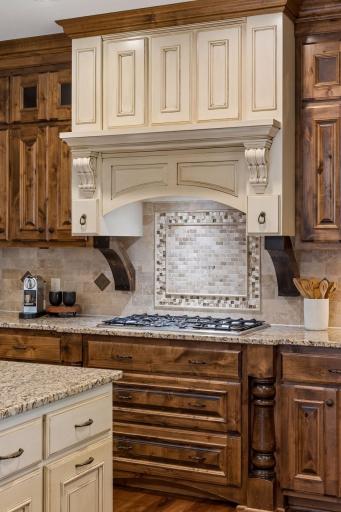 View of the beautiful 5-burner gas cooktop with exhaust hood and convenient pull-out drawers for your pots and pans.