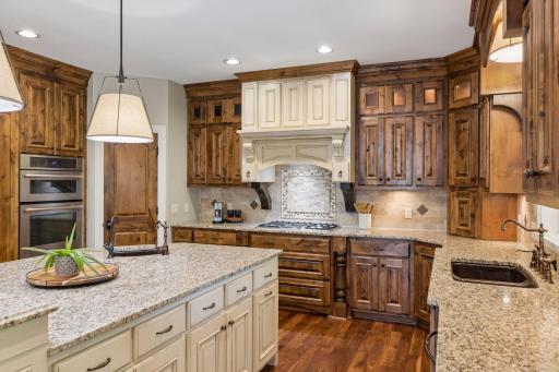 The kitchen features a wall oven, convection and microwave, refrigerator, dishwasher, gas cooktop, prep sink in the island and a disposal.