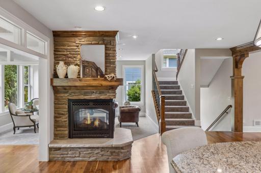 The main level centers around a cozy 3-sided stone fireplace with a beautiful wood mantel.