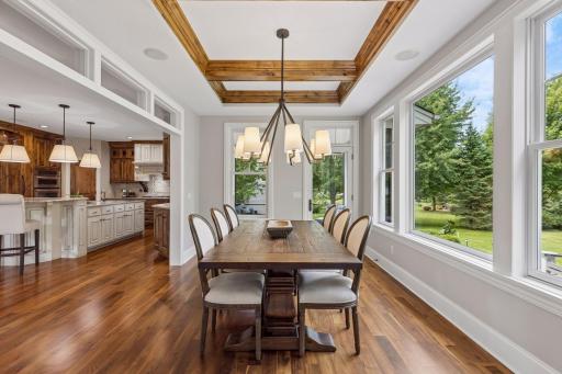 View of the kitchen and dining room with the wood coffered ceiling.