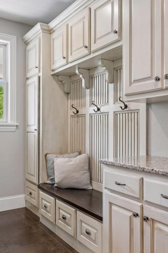 The mudroom features a convenient bench with abundant storage.