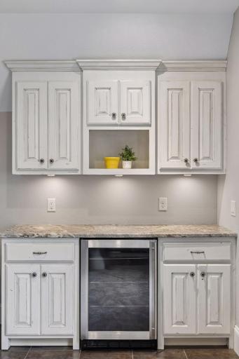 A closer view of the built-in cabinets and beverage refrigerator.