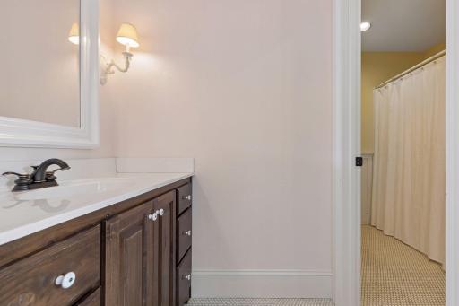 Each of these two bedrooms share a full bath with individual vanities with storage.