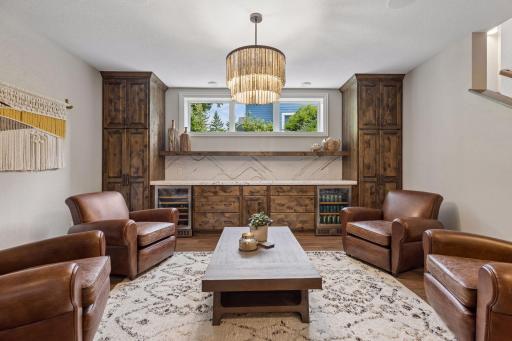 Enjoy entertaining family and friends in this beautiful bar and entertainment center that includes built-in knotty alder cabinets, Cambria countertop, daylight windows and two refrigerators - beverage and wine.