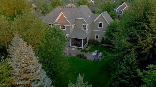 Twilight backyard photo. Mature trees create a private setting.