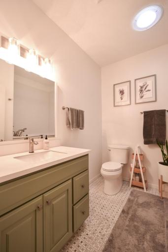 Guest bathroom updated with new tile, cabinet/countertip, lights and added sky light for more natural light.