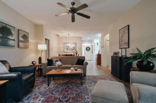 over view of the living room, dining room, foyer area. To the right door way is the guest bath and 2nd bedroom.