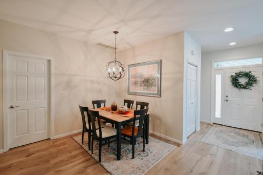 Beautiful new high end luxury vinyl planking runs through the common areas of the house; front foyer back to the sun room. New light fixture and notice the new front door.