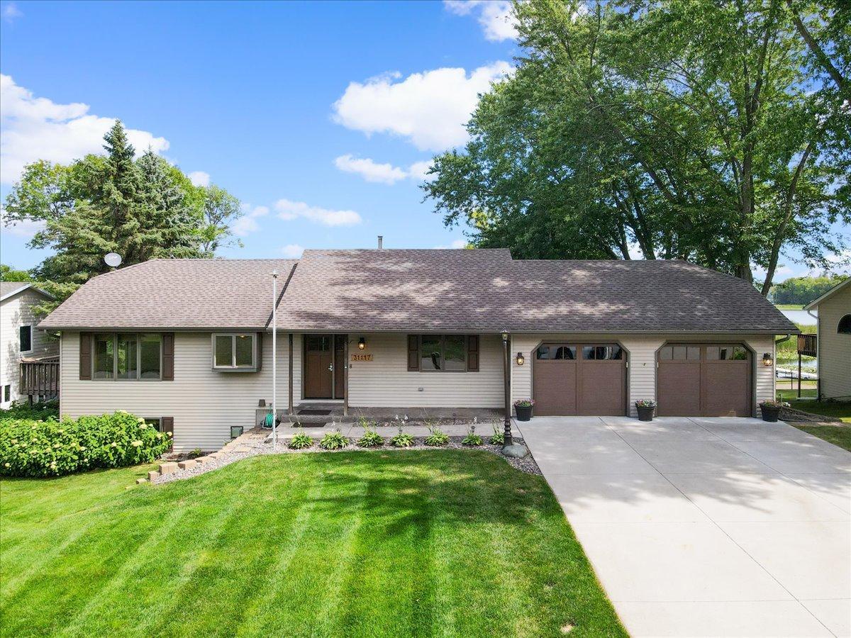 Welcome to Lake Life in Lindstrom A beautifully maintained North Center Lake home with an attached two-car garage and inviting curb appeal.