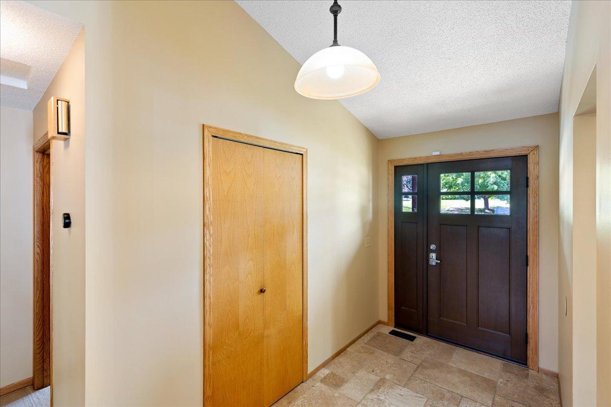 A Bright and Practical Entryway Natural light, tile flooring, and a convenient coat closet make arrivals organized and inviting.