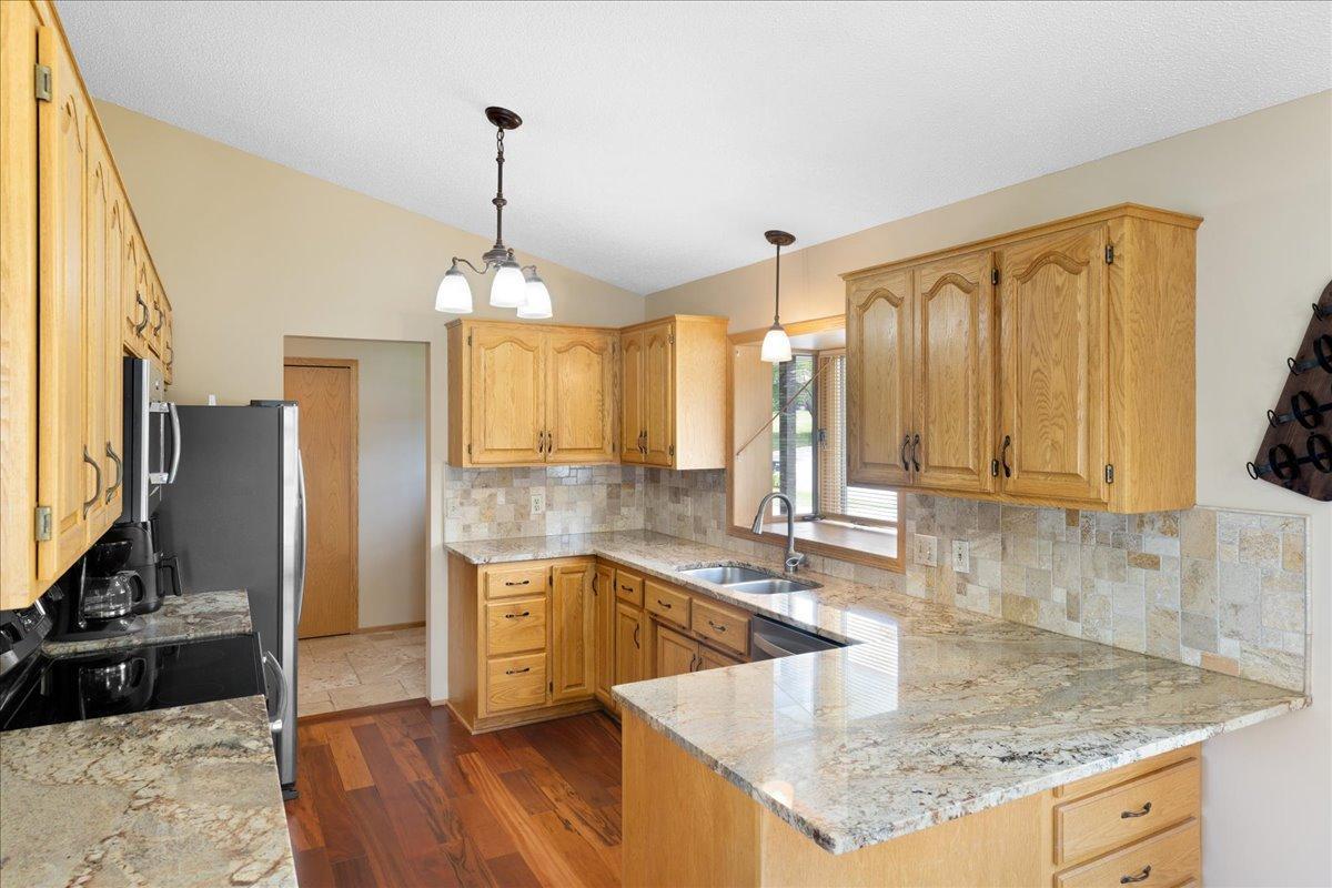 Plenty of Room to Prepare and Gather Generous cabinetry and expansive granite countertops make this Lindstrom lake home’s kitchen ready for meals, celebrations, and company.