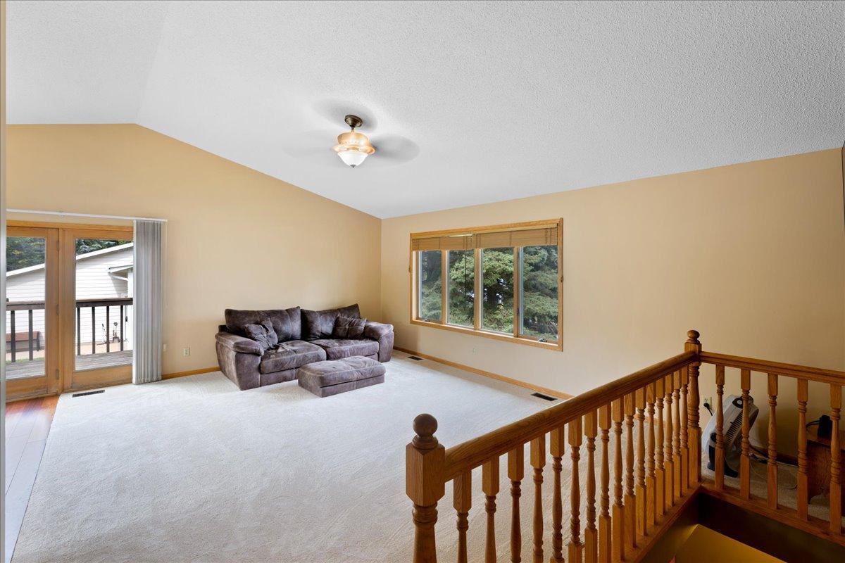 Comfortable Space to Make Your Own This generously sized living area offers flexible furniture arrangements and easy access to the adjoining deck.