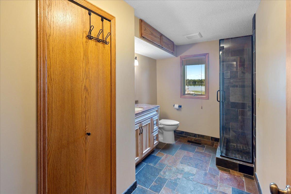 Lower Level Bathroom updated with Slate and solid finishes.