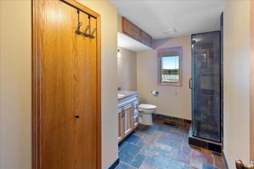 Lower Level Bathroom updated with Slate and solid finishes.