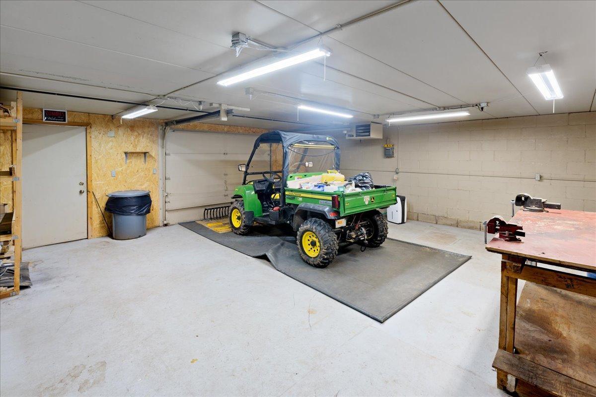 The 24-by-24 Heated Lakeside Workshop Located beneath the spancrete garage, this remarkable workshop provides year-round space for projects, equipment, hobbies, and lake gear.