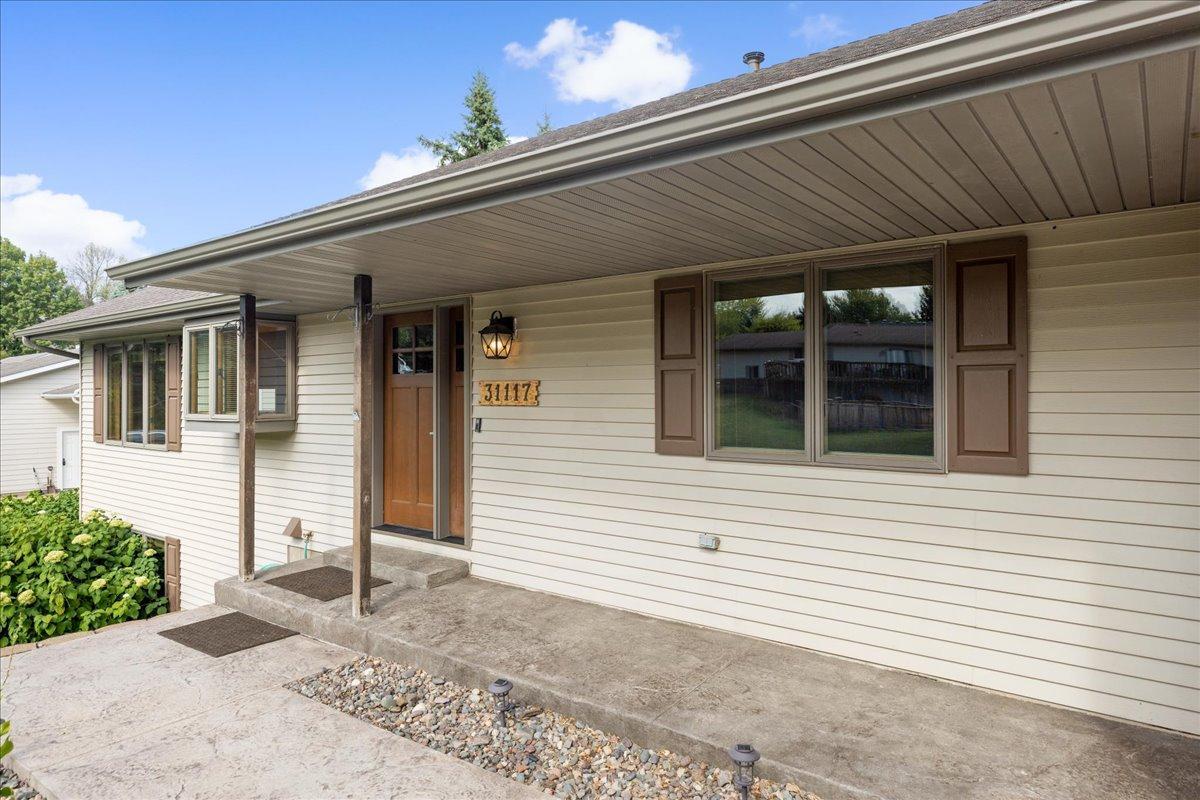 A Warm Welcome at 31117 Peninsula Avenue The covered front entry introduces a comfortable Lindstrom home created for year-round lake living.