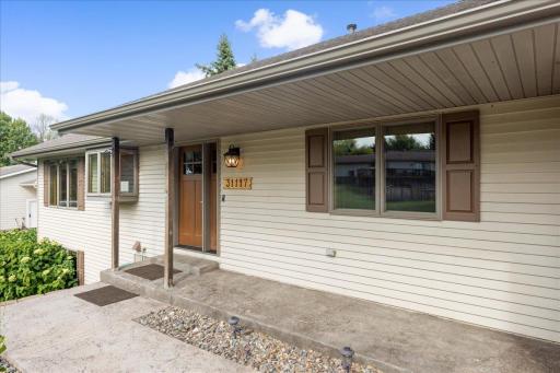A Warm Welcome at 31117 Peninsula Avenue The covered front entry introduces a comfortable Lindstrom home created for year-round lake living.