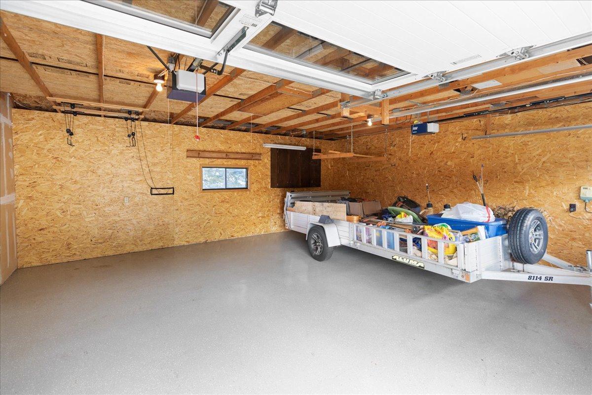 2+ car garage with new overhead doors, epoxy floors and paneled walls
