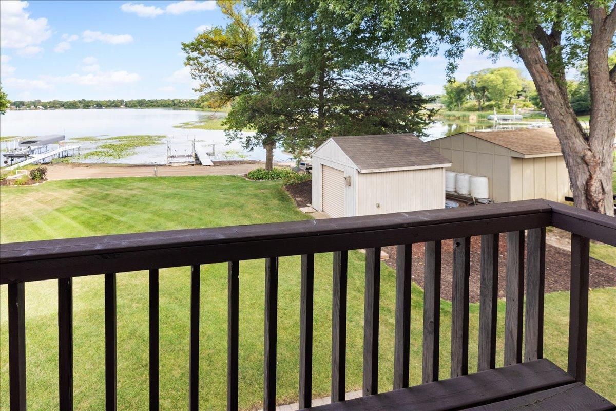 Imagine Waking Up to This View The private balcony off the bedroom suite overlooks the lawn and North Center Lake’s peaceful shoreline.