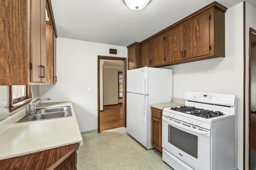 The kitchen is conveniently positioned between the formal and informal dining areas.