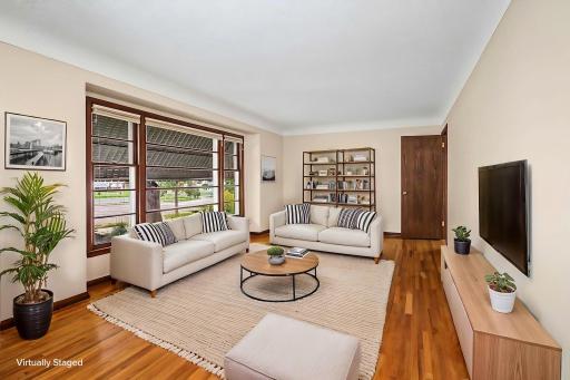 Sprawling living room virtually staged to show the fabulous living and entertaining space this room welcomes. Note the soft coved ceiling detail.