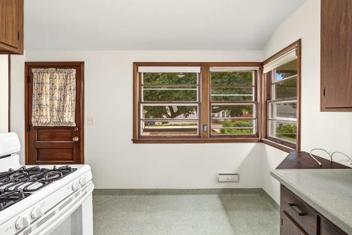 Windows that wrap the informal dining area display a beautiful backyard view.