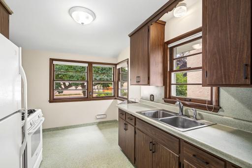 Bright and cheery kitchen with a functional design and windows galore.