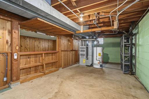 Large unfinished mechanical and storage area with room for potential expansion. Note, back side of bar showing bar open.