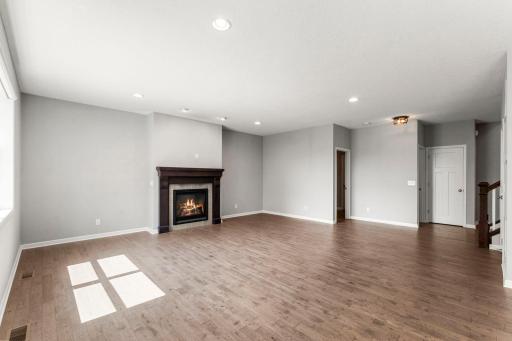 Rich wood flooring carries throughout the main level, connecting each space and creating an easy, natural flow for everyday living and entertaining.