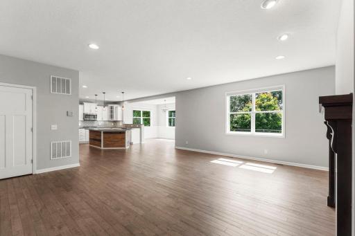 Step inside to a main level that immediately feels bright, open, and inviting. The two-story entry with 18-ft ceilings makes a statement from the moment you walk through the door, while natural light pours into every corner.