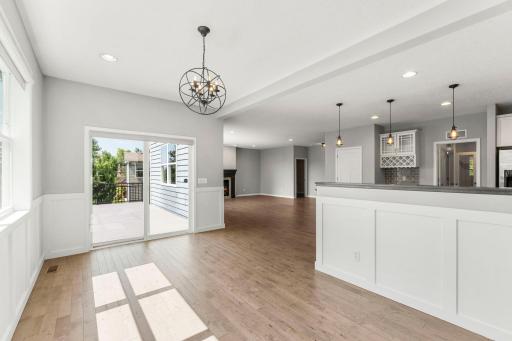 Sliding doors open to the maintenance-free deck, creating an effortless indoor-outdoor connection and peaceful views of the wetlands beyond.