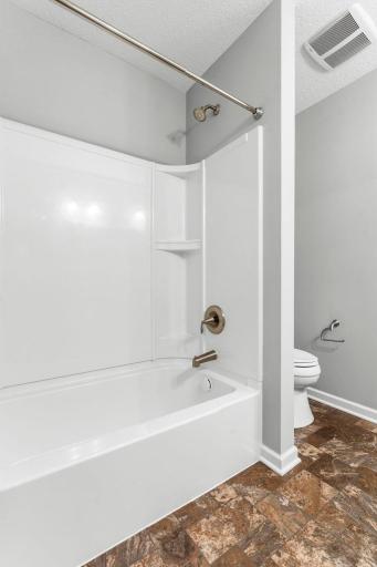 A shared full bath with dual sinks serves the upper level.