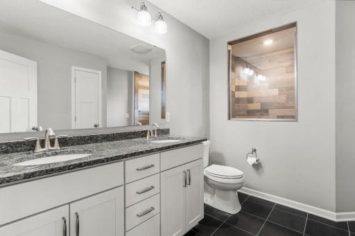 Beautiful ensuite with dual vanity and timeless finishes.