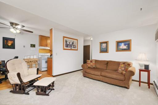 The open-concept living area flows seamlessly into the dining and kitchen spaces, creating an efficient and versatile layout.