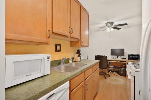 The functional kitchen includes a gas range, ample workspace, and plenty of storage to keep everything organized.