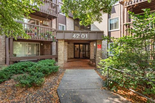 Secure, well-maintained building entrance with convenient main-level access and beautifully landscaped common grounds.