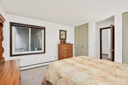 Large bedroom with oversized window, excellent natural light, and convenient access to the adjoining bath.