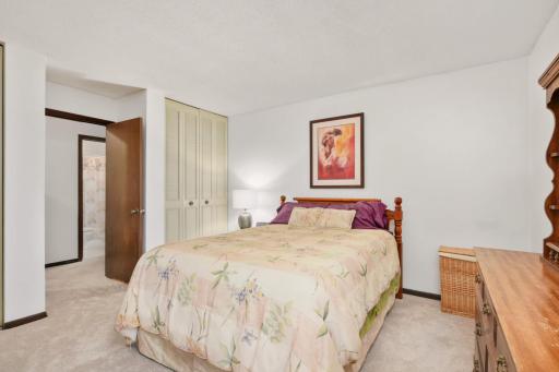 A bright and inviting primary suite featuring abundant closet space and a comfortable, relaxing atmosphere.