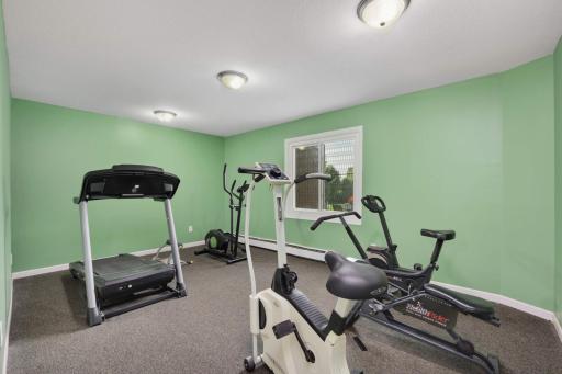 Stay active without leaving home in the community fitness room featuring cardio equipment and workout space.