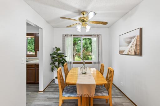 Gather around the table in a dining room filled with natural light, and new vinyl plank flooring.