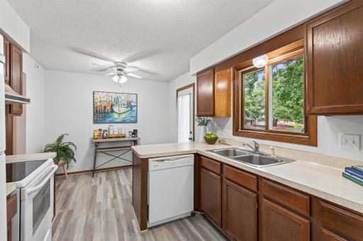 This kitchen offers a a great view of the lush backyard while preparing your meals.