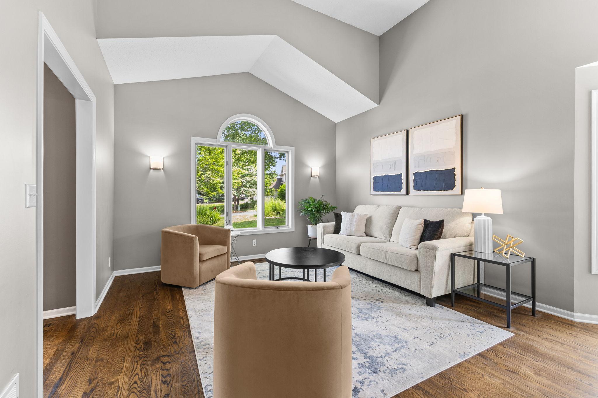 Sunlight pours through oversized windows, creating a warm and welcoming place to unwind.