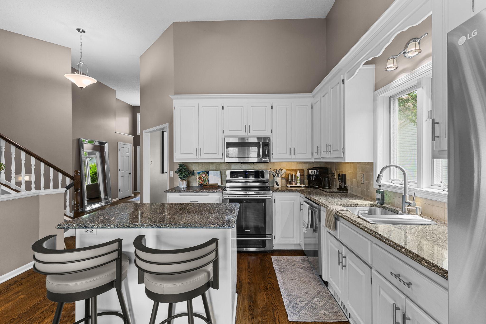 Timeless updated white cabinetry pairs beautifully with granite countertops and abundant prep space.