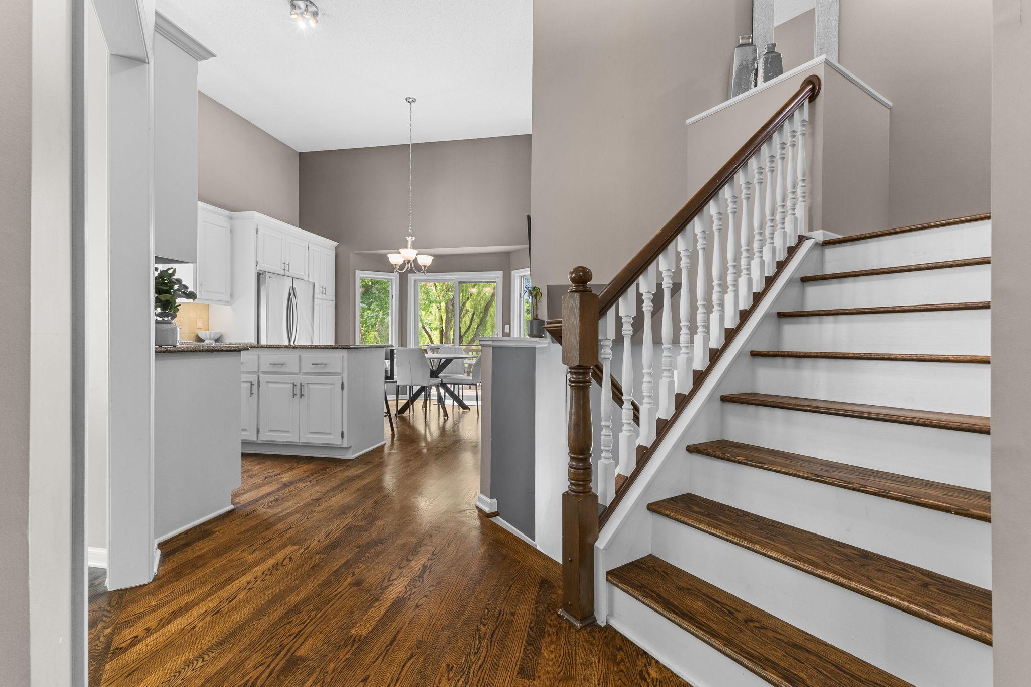 The staircase creates a beautiful architectural focal point at the heart of the home.
