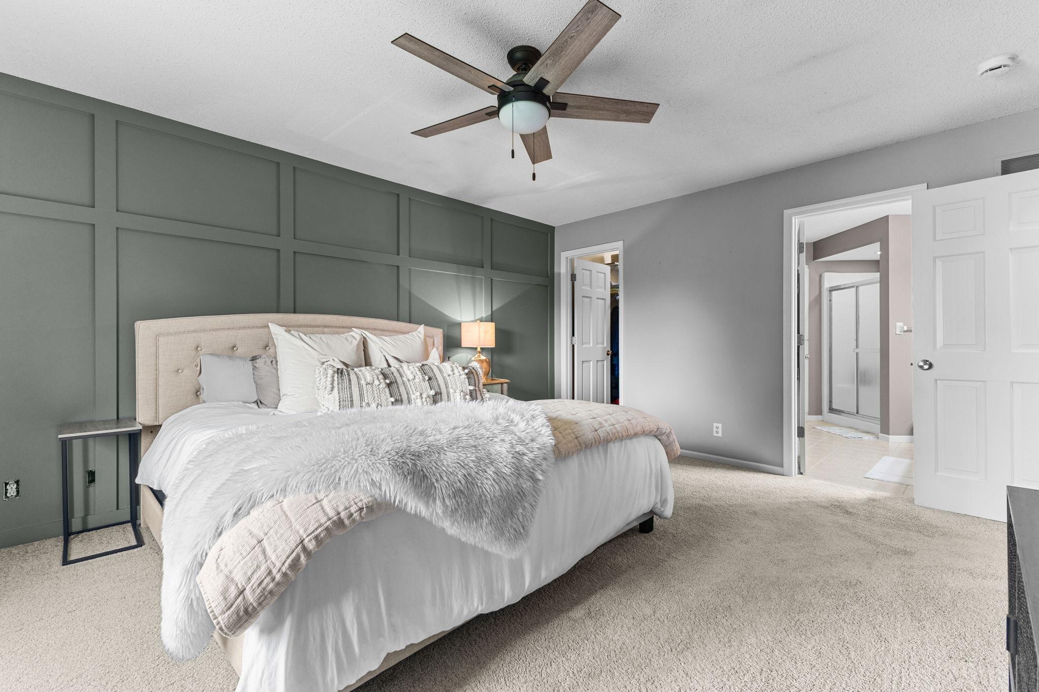 Custom accent wall adds warmth and character to the primary retreat.