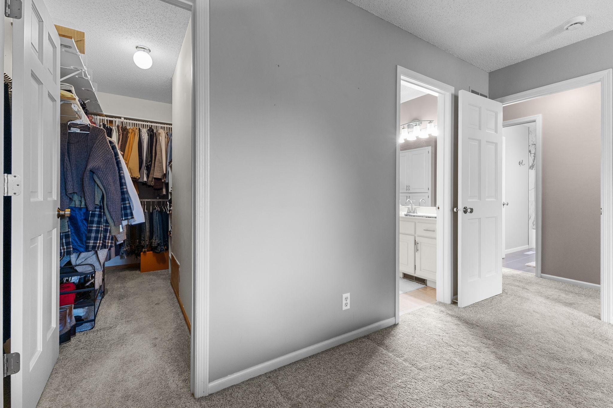 A walk-in closet offers generous storage and everyday convenience.